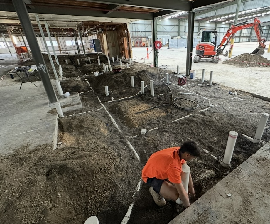 In-ground plumbing rough-in on a large warehouse site