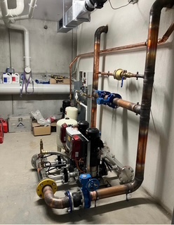 Commercial plant room with copper pipework and pumps